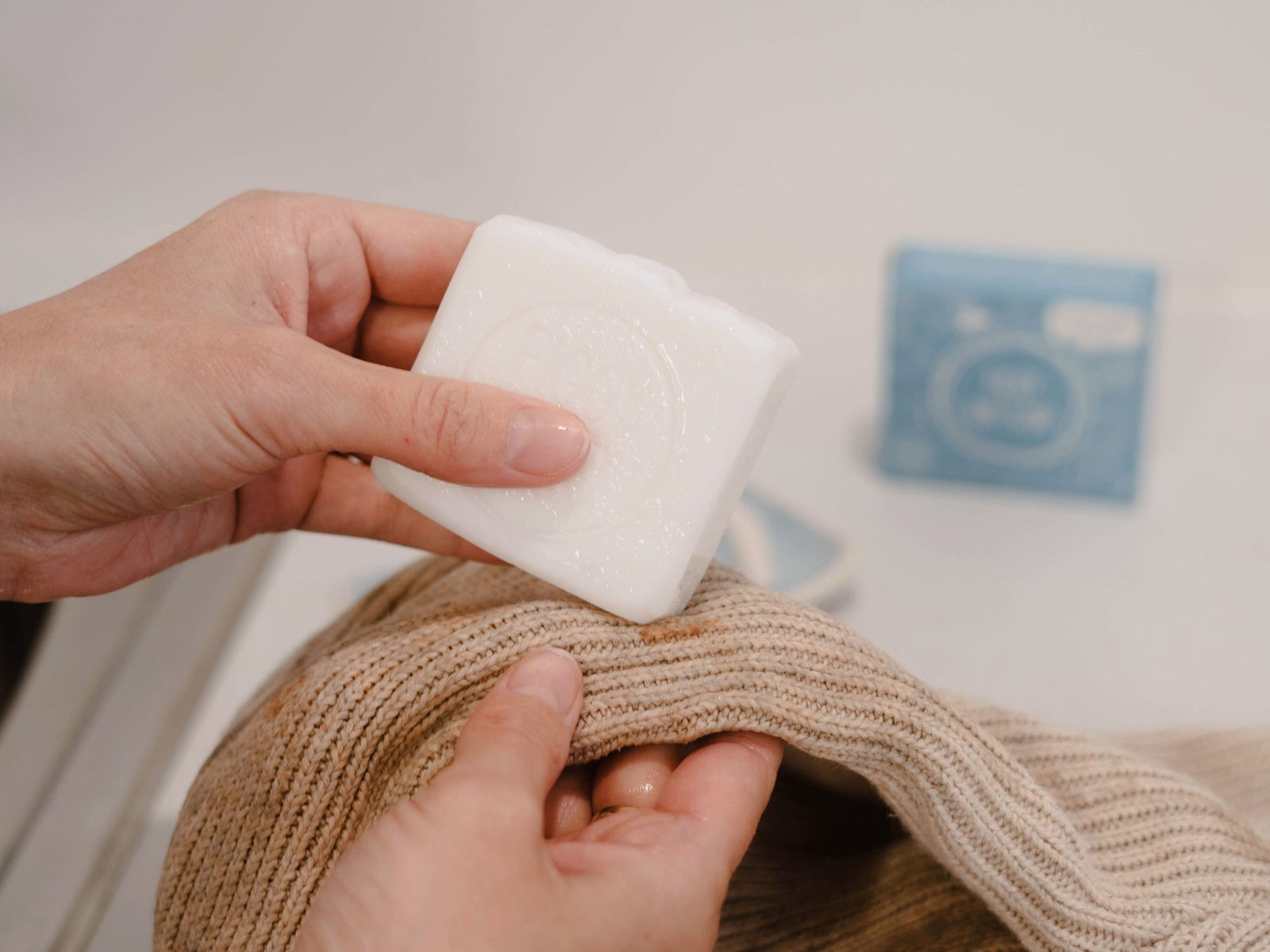 suds up the mark by rubbing the bar soap directly onto the stain