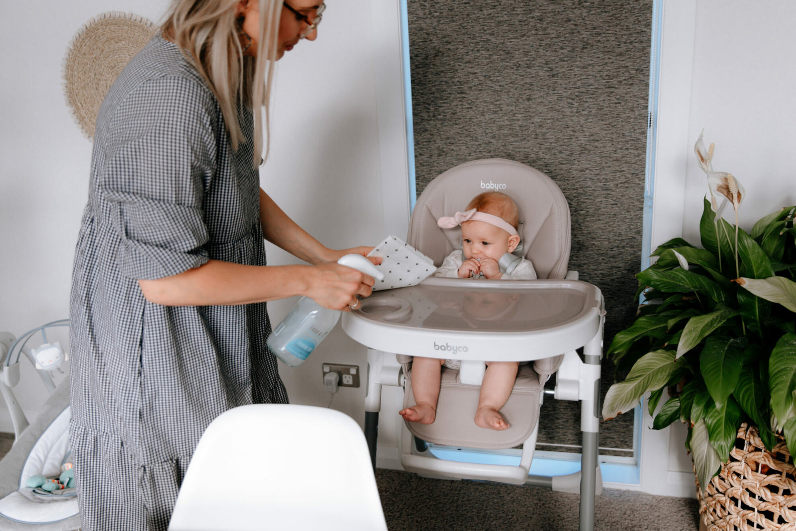 Mother cleaning babies highchair