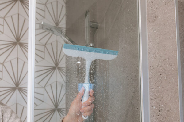 use a shower squeegee to remove water and dry off your shower