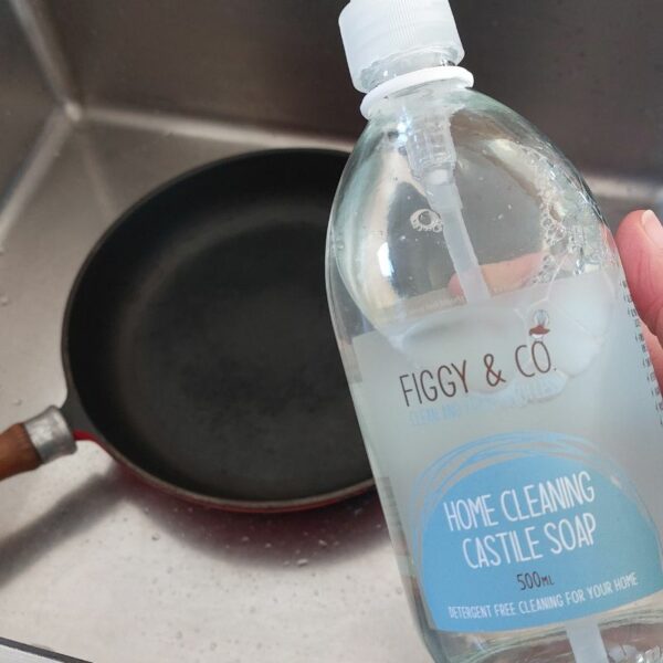 Wash you cast iron pan with soapy water to remove any food residues